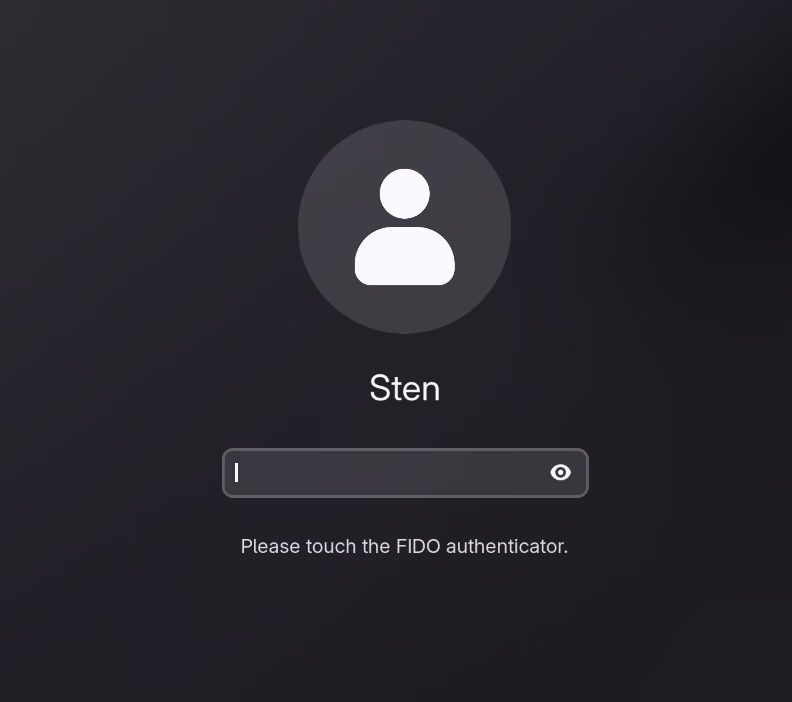 GNOME lock screen showing “Please touch the FIDO authenticator.”